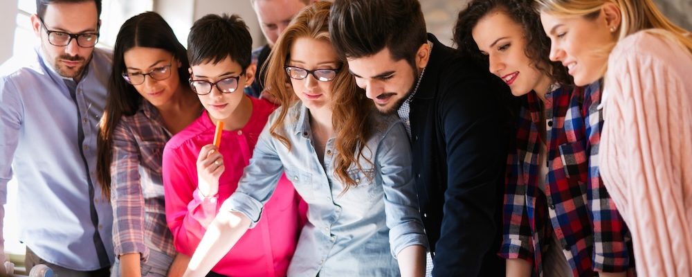 Picture of young attractive architects discussing in office